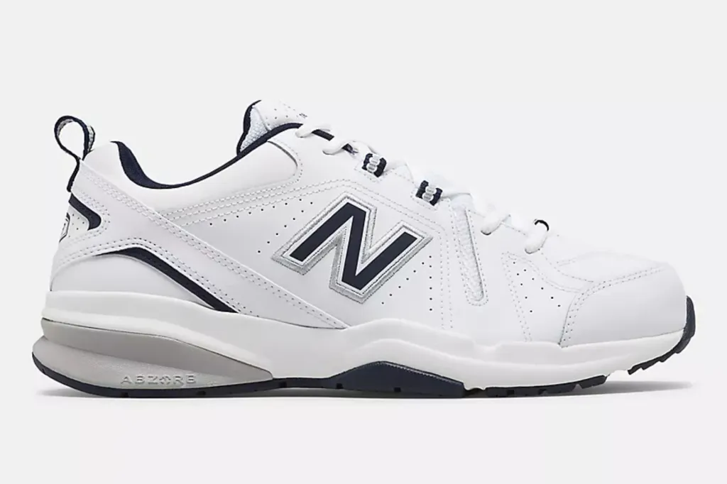 A white running sneaker with the New Balance logo.