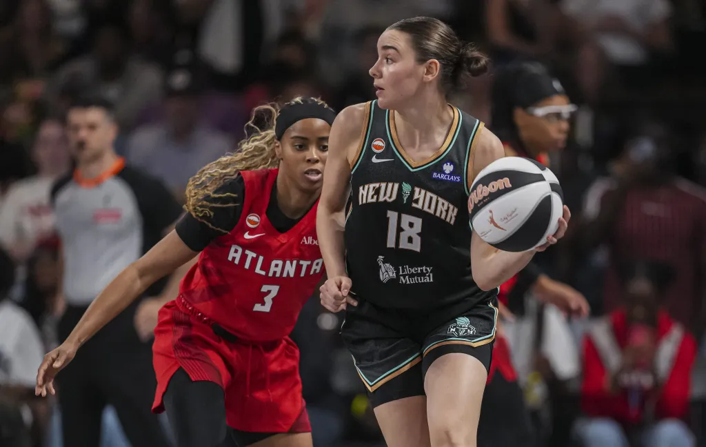 Pauline Astier, who scored 16 points, looks to make a pass in front of Jordin Canada during the Liberty's road win over the Dream.