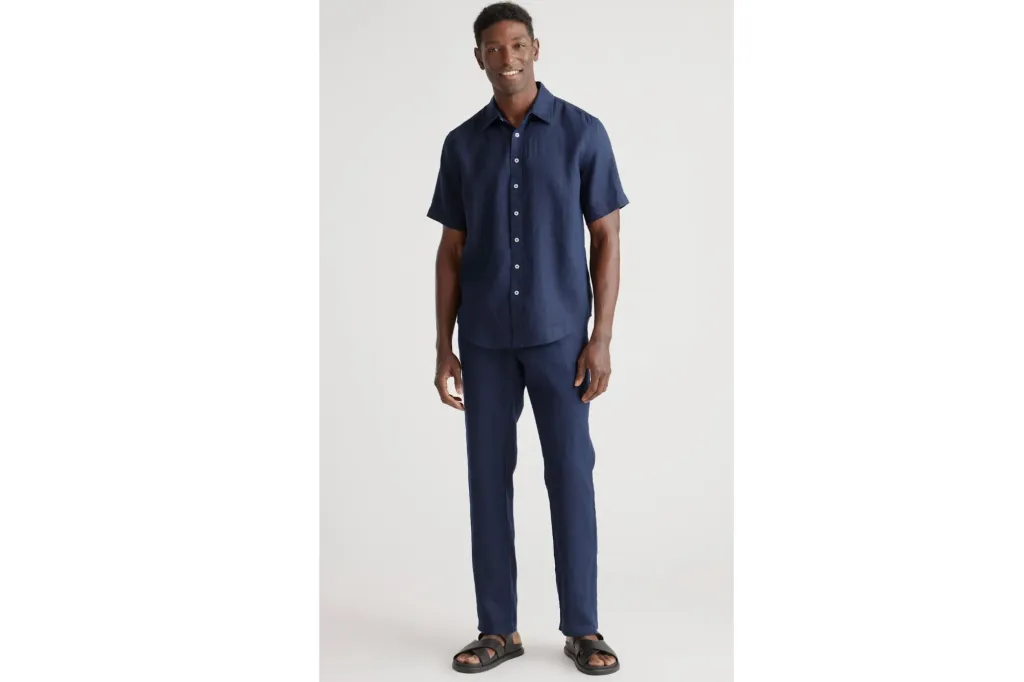 A man wearing a blue linen shirt.