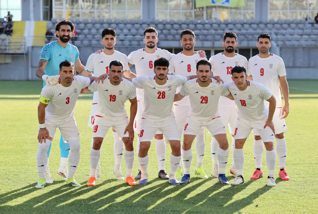 The Iranian national football team poses for a group photo before the game.