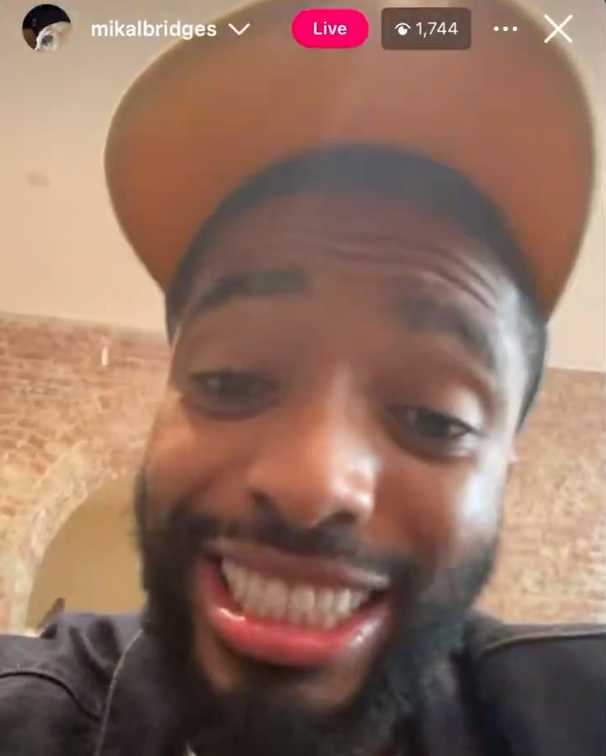 Mikal Bridges live on Instagram, grinning at the camera.