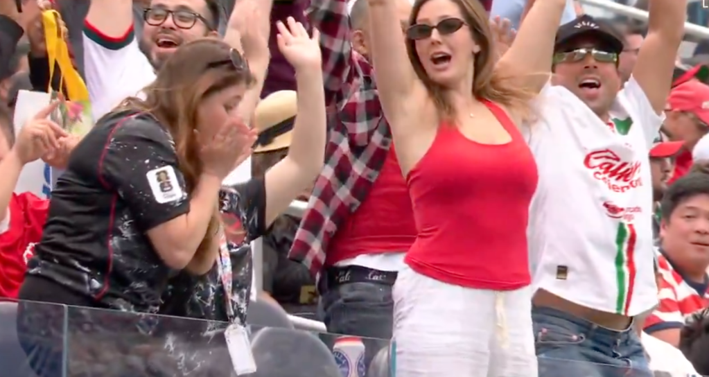 A crowd of excited fans cheering.