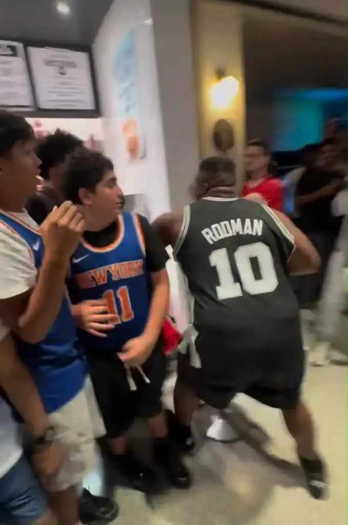 A Spurs fan tries to fight Knicks fans inside Moynihan Train Hall at Penn Station after the Knicks' NBA championship win on June 13, 2026.