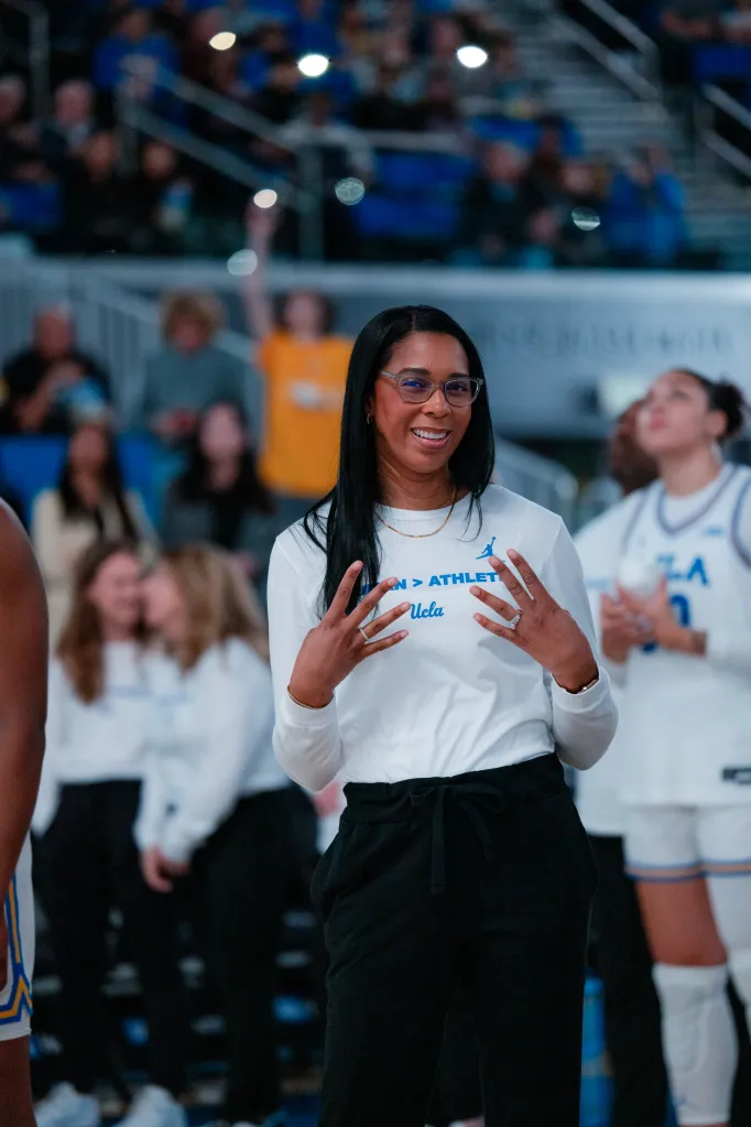 Shannon LeBeauf standing courtside at a basketball game.
