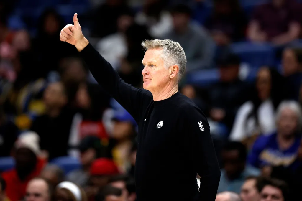 Steve Kerr, the Golden State Warriors coach, giving a thumbs-up during a game.