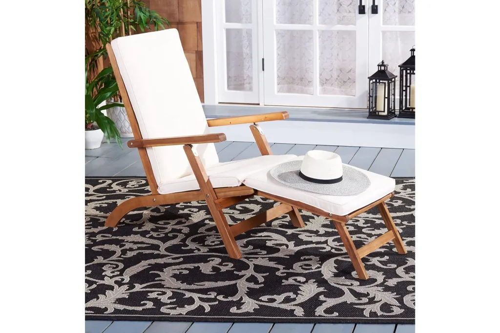 A lounge chair with a hat on it.