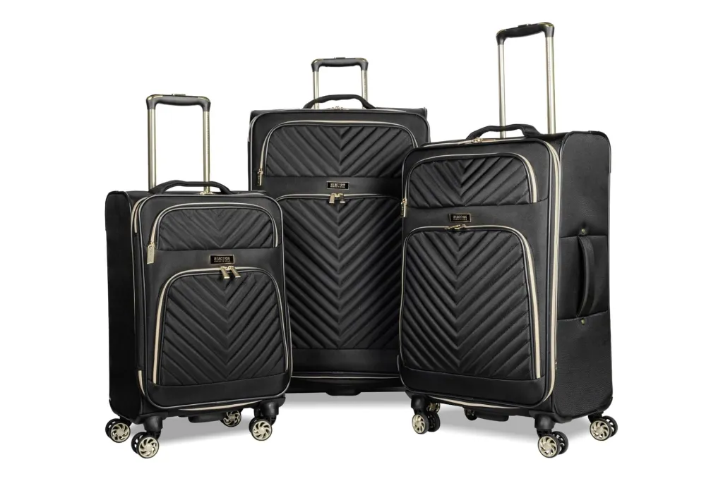 A three piece luggage set from Kenneth Cole in the colors black and gold
