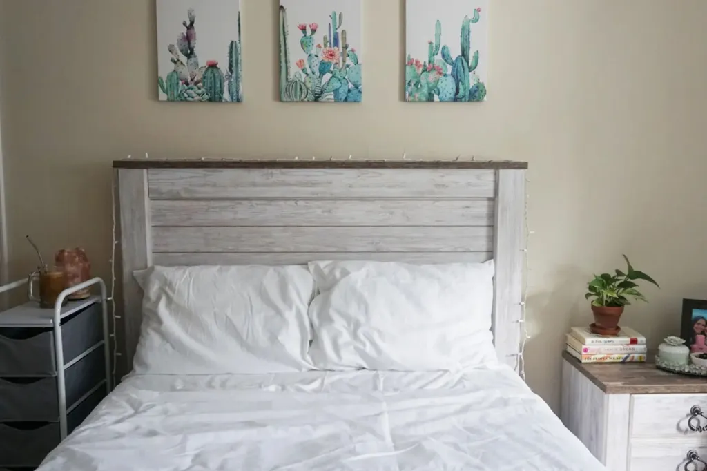 A bed with white sheets.