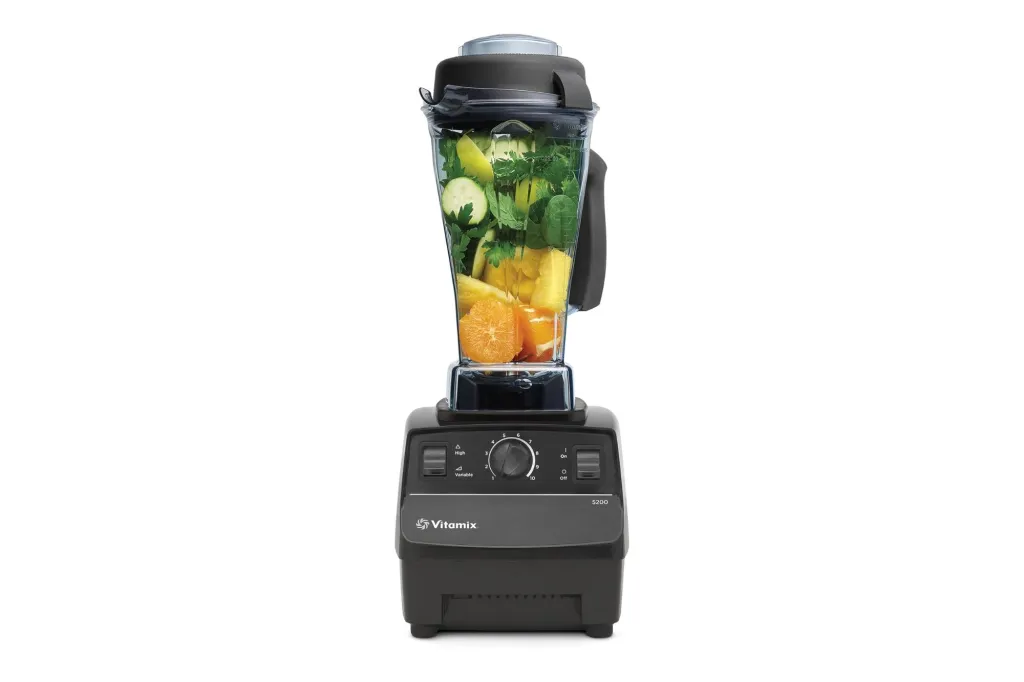 A blender with fruit in it.
