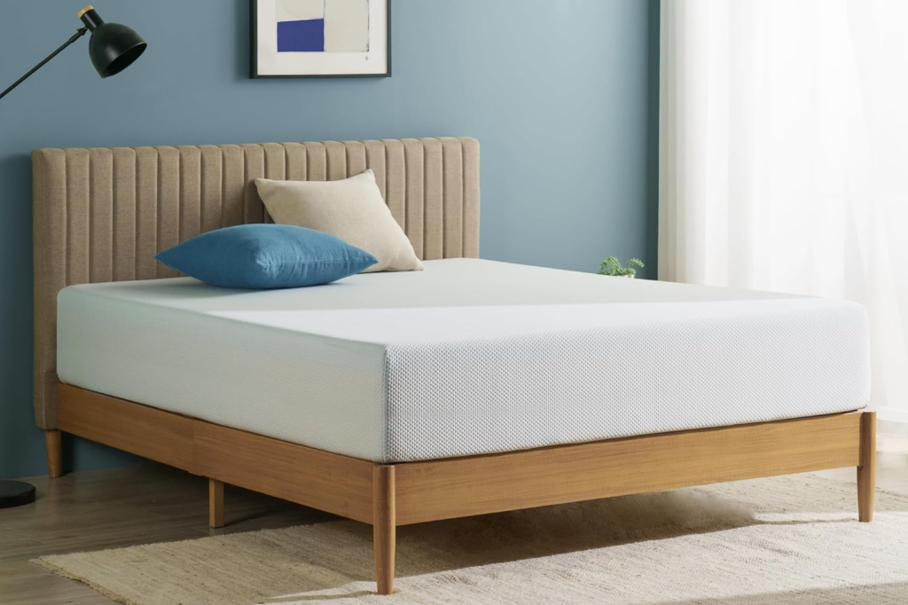Zinus bed with a light wood frame and a beige upholstered headboard.