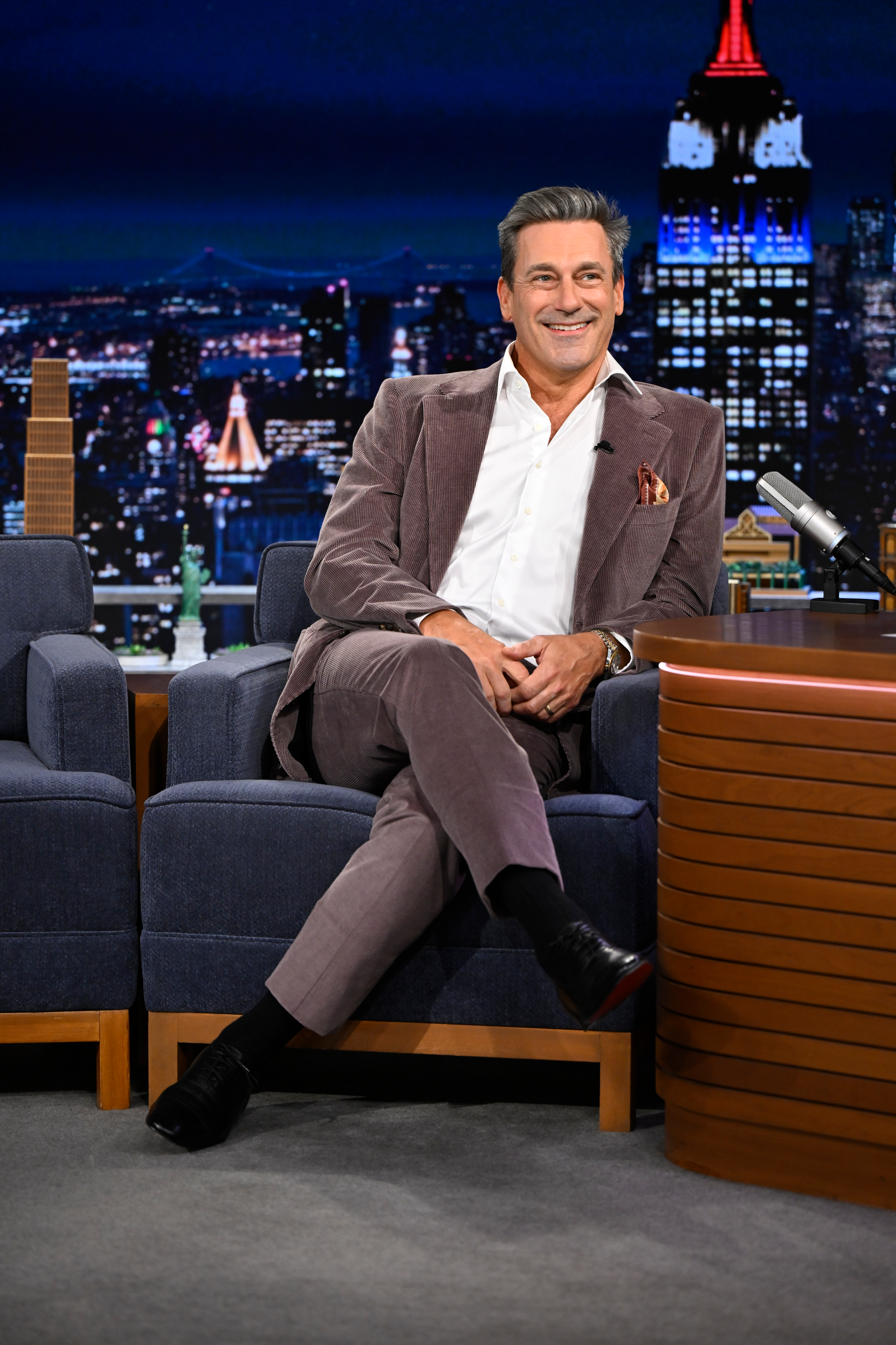 Jon Hamm sitting and smiling during an interview on "The Tonight Show."