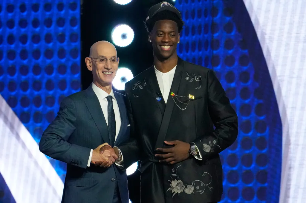 AJ Dybantsa poses for a photo with NBA commissioner Adam Silver, left, after being selected by the Washington Wizards as the first pick in the first round of the NBA basketball draft, Tuesday, June 23, 2026, in New York.