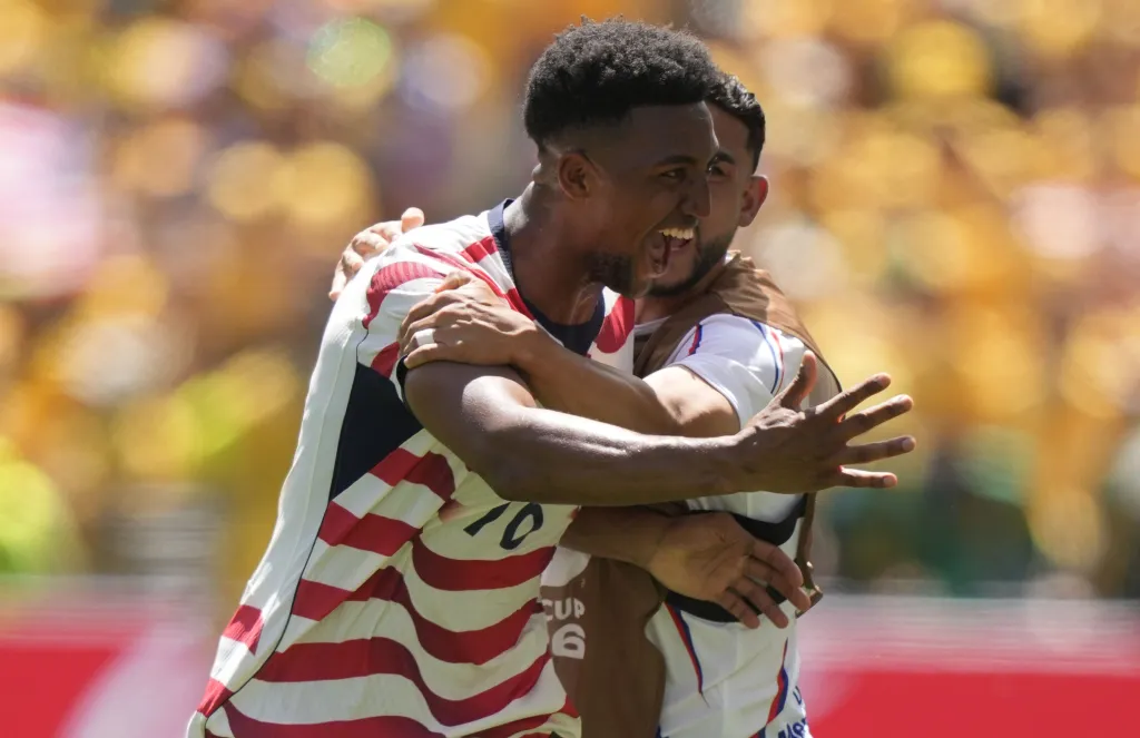 Alex Freeman of USA celebrates a goal with a teammate during the FIFA World Cup 2026 group stage match against Australia.