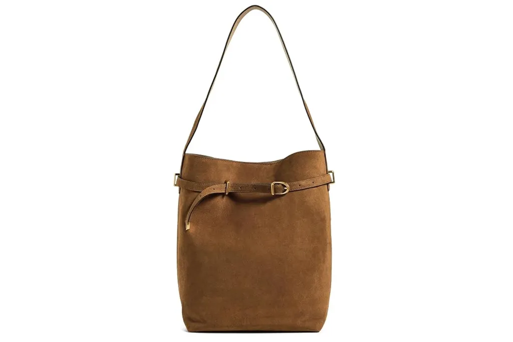 Brown suede shoulder bag with a thin strap and a decorative belt detail around the top.