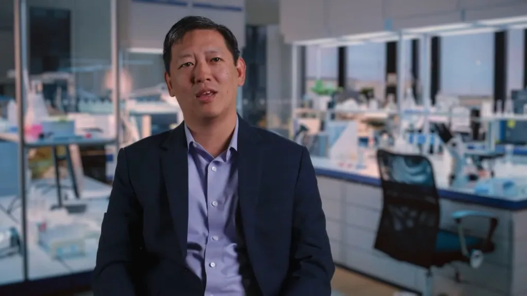 Felix Fang, founder of GenEdit, speaking in a lab.