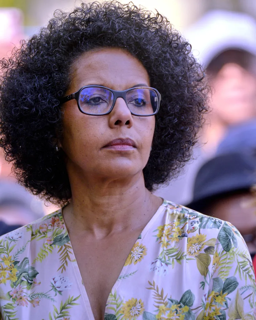 Audrey Pulvar, Deputy Mayor of Paris, looking off into the distance while attending a commemorative ceremony.