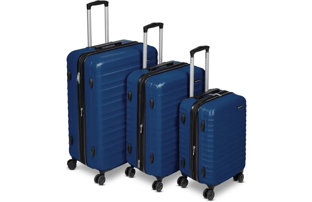 Set of three blue rolling suitcases.