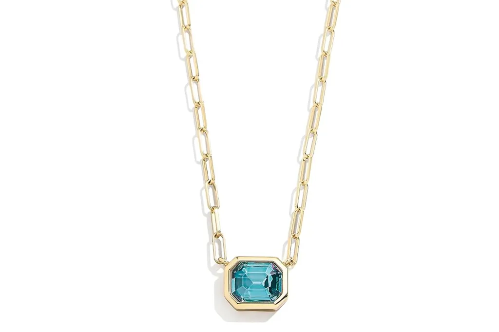 Gold chain with a rectangular blue jewel in the center.