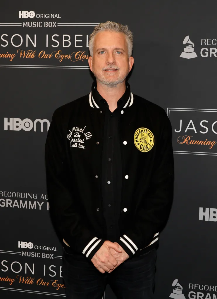 Bill Simmons wearing a black Muhammad Ali letterman jacket.