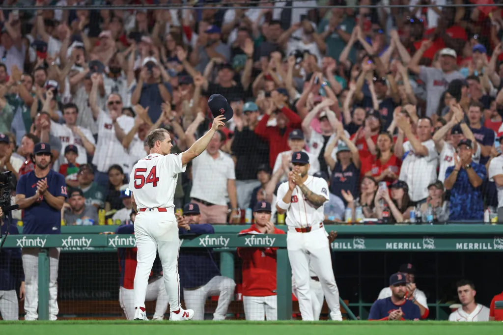 Boston Red Sox pitcher Sonny Gray (54) waves to the crowd while holding his cap during the eighth inning at Fenway Park.