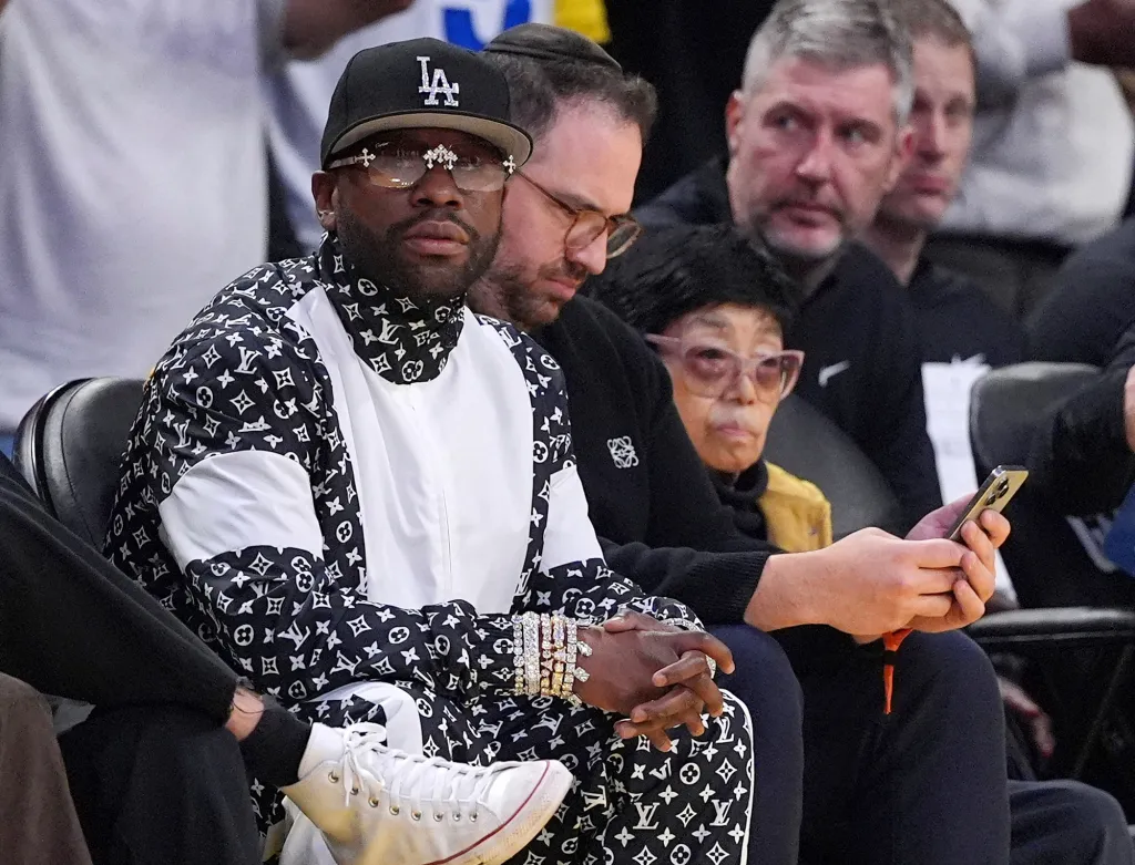 Floyd Mayweather sitting courtside during an NBA basketball game.