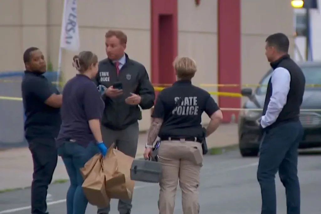 Police officers and investigators at the scene of a shooting in Brockton, Massachusetts.