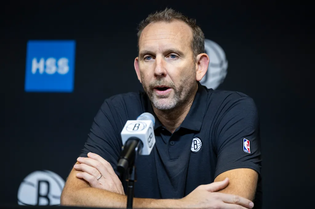 Brooklyn Nets GM Sean Marks speaks into a microphone during post-season interviews.