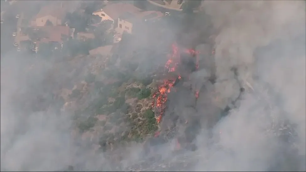Aerial view of a brush fire burning near homes in Stevenson Ranch, Santa Clarita Valley.