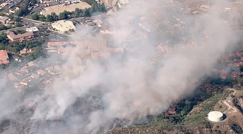 Aerial view of a brush fire burning near homes in Stevenson Ranch, Santa Clarita Valley.