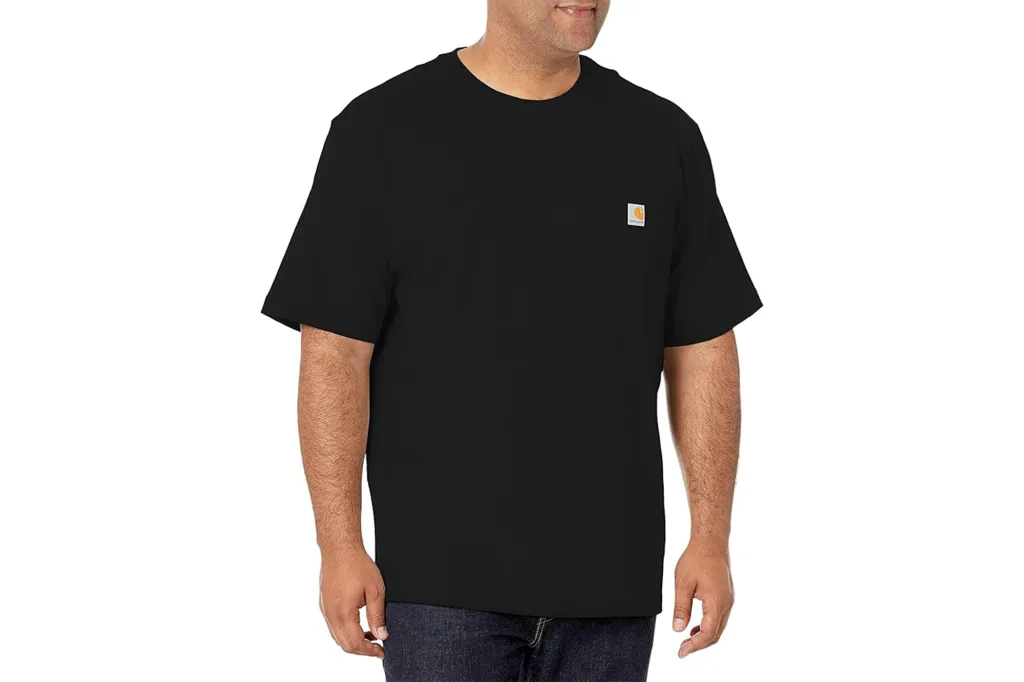 A man models a black Carhartt t-shirt with a small logo on the left chest.