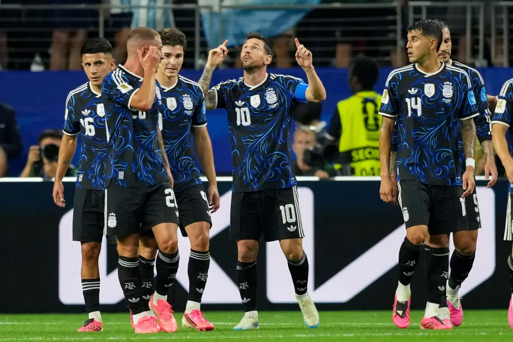 Lionel Messi celebrates scoring a goal with his teammates.