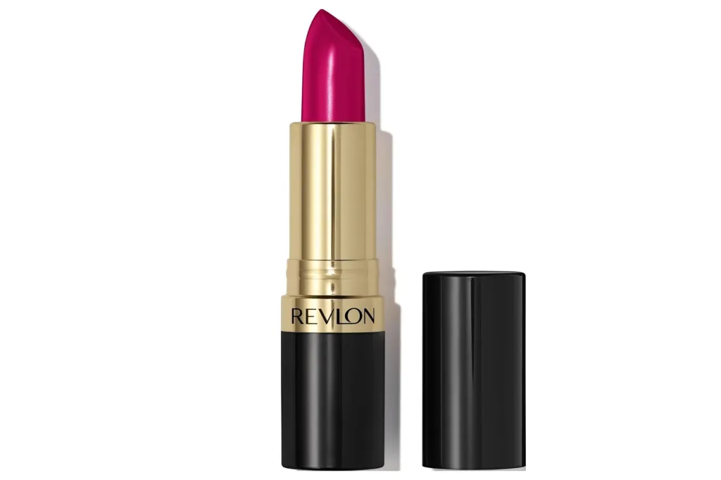 A Revlon lipstick in a vibrant fuchsia shade, with a black and gold case, shown with its cap off.