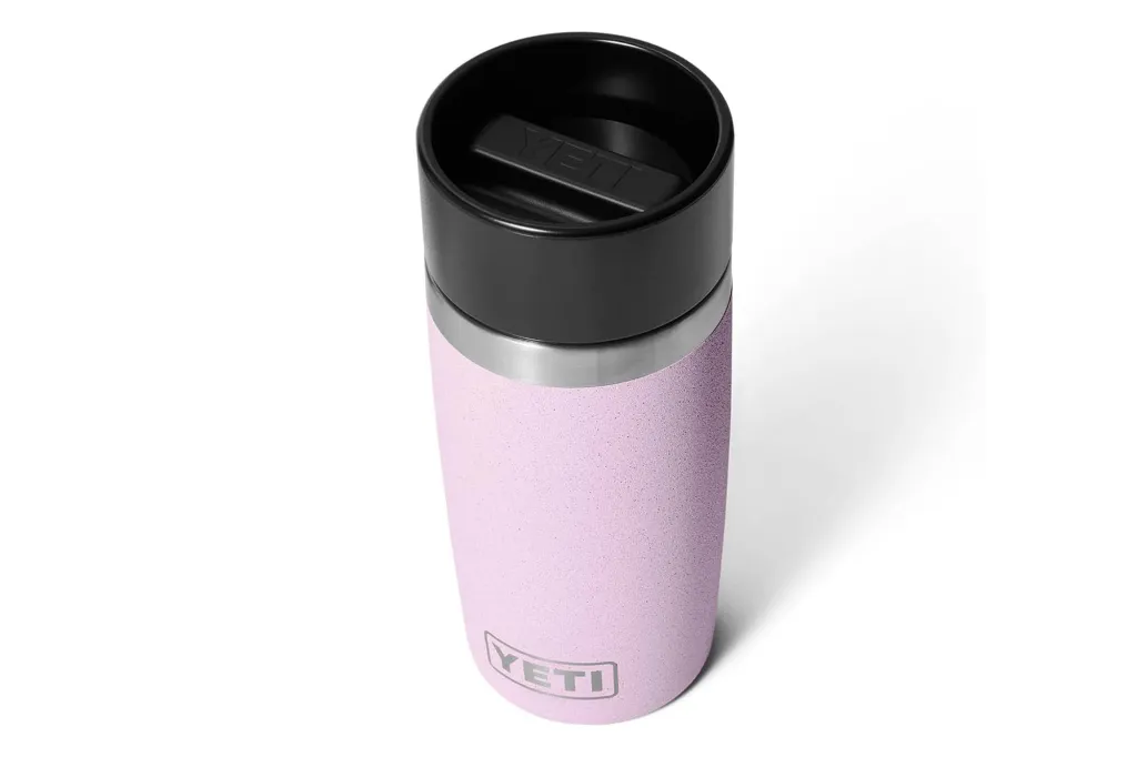 Pink YETI Rambler travel mug with a black lid.