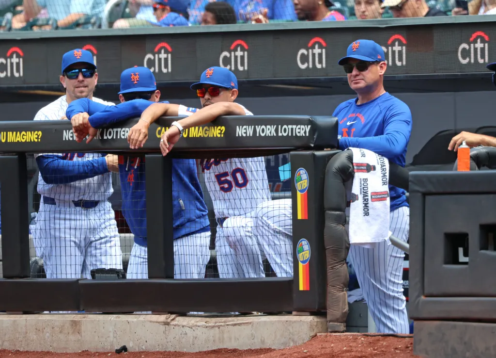 New York Mets manager Carlos Mendoza #64 in the dugout during the first inning of a game against the Chicago Cubs at Citi Field.