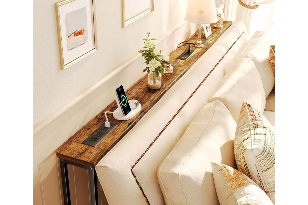 Console table with built-in power outlets and charging station next to a sofa.