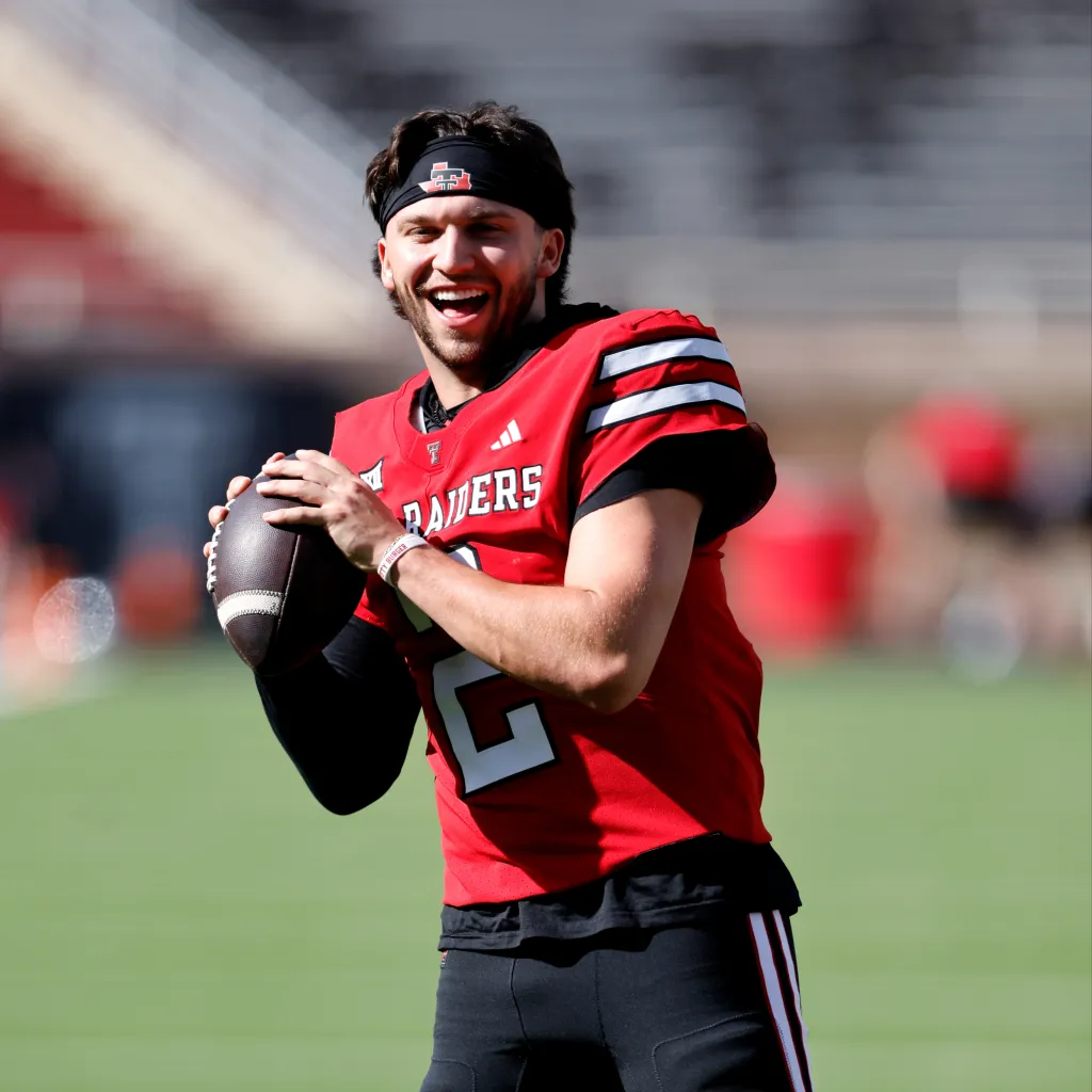 Brendan Sorsby #2 of the Texas Tech Red Raiders smiles while holding a football.