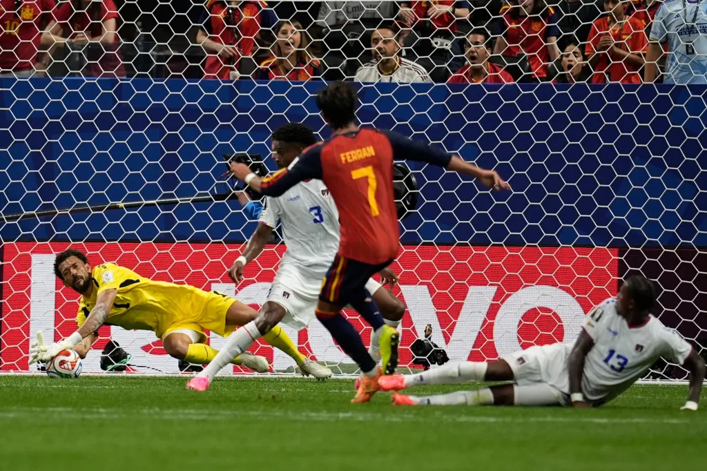 Cape Verde goalkeeper Vozinha, left, makes a save after shot by Spain's Ferran Torres (7) during the World Cup Group H soccer match between Spain and Cape Verde in Atlanta, Monday, June 15, 2026.