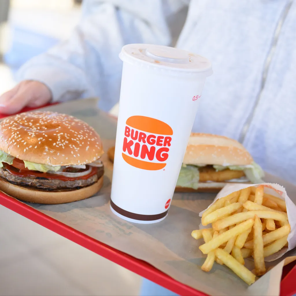 Illustration of a Burger King tray with a plant-based Whopper, a Long Chicken, fries, and a drink.