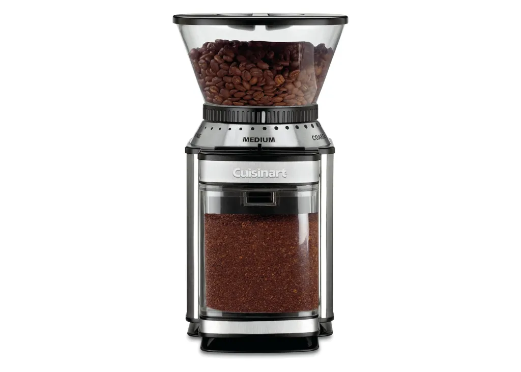 A Cuisinart coffee grinder with whole coffee beans in the top hopper and ground coffee in the bottom container.
