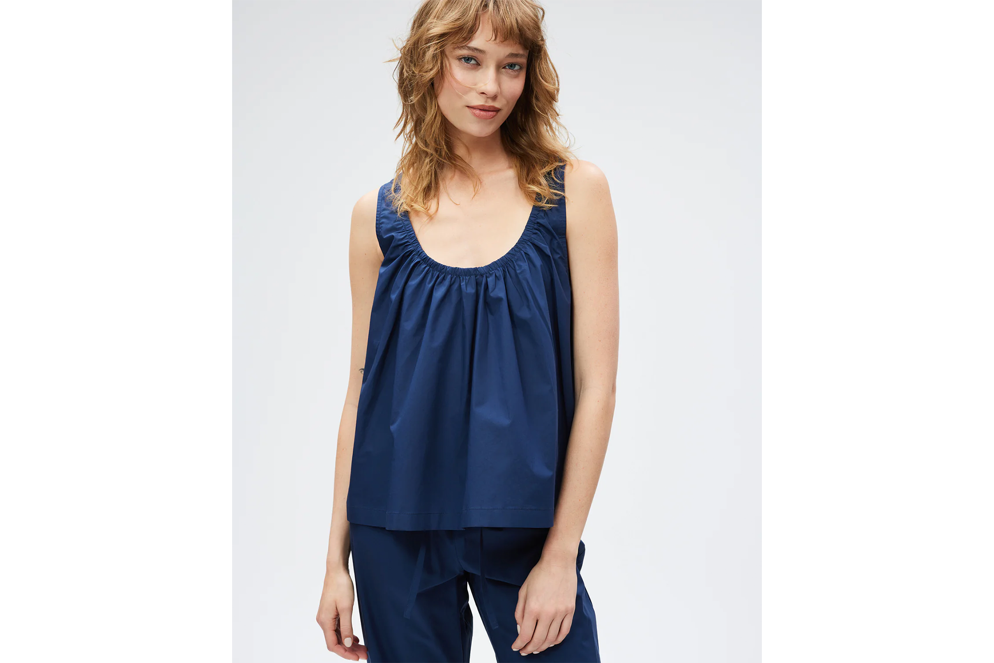 A woman in a navy blue top and matching pants.