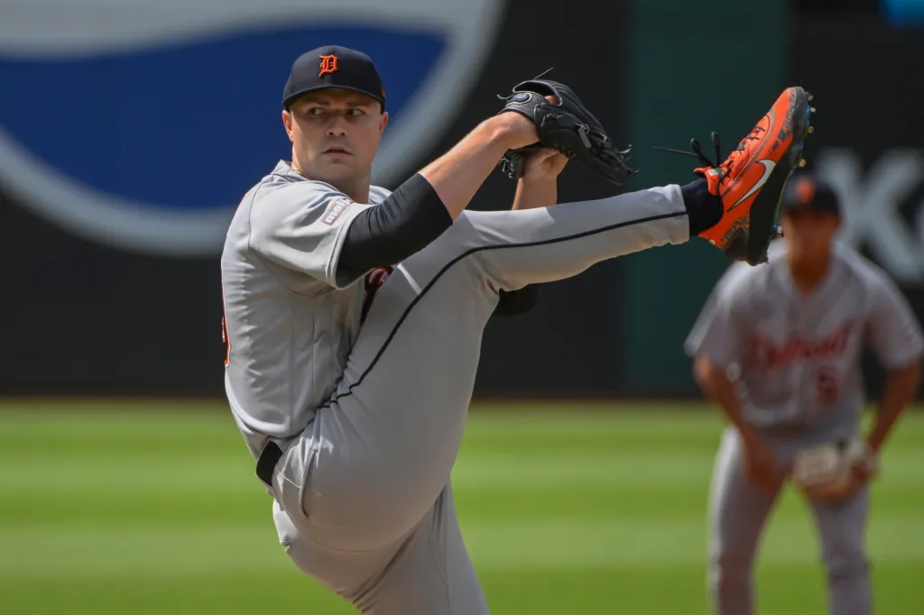 Tarik Skubal mid-pitch, wearing a grey uniform with a Detroit Tigers cap.