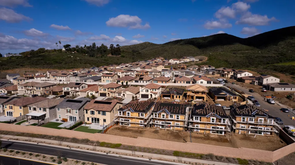 A drone view shows single-family homes at a new subdivision under construction in the rural hills of San Marcos, California, on March 25, 2024. 