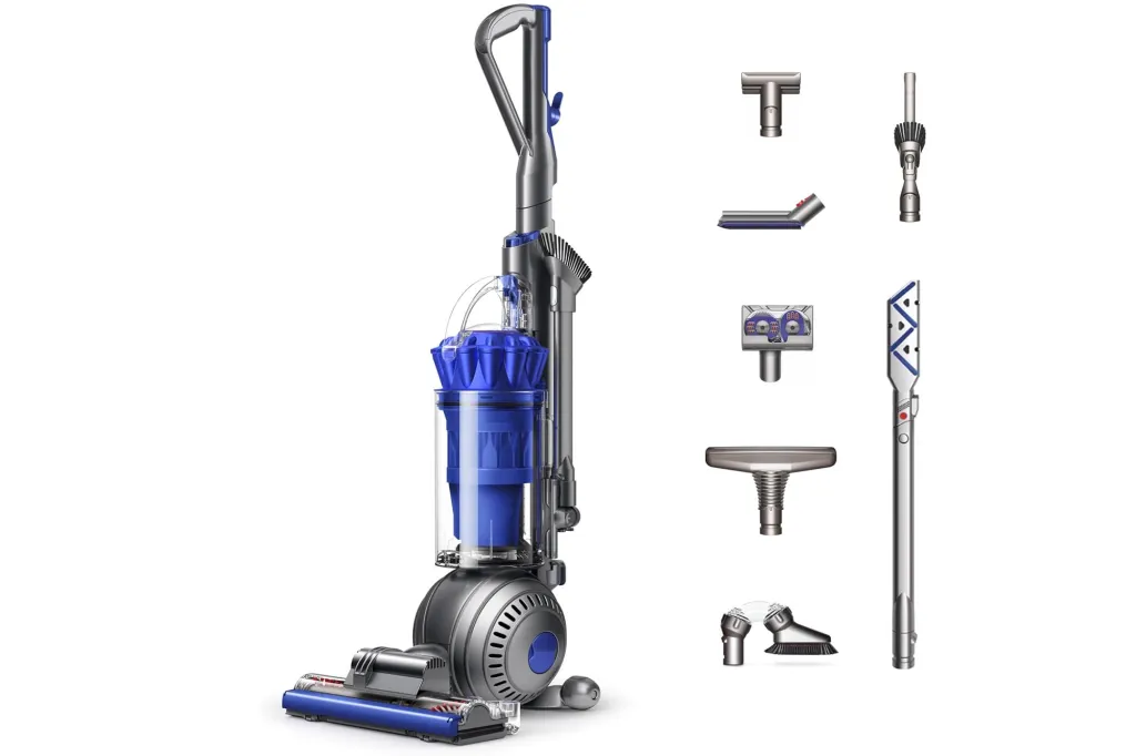 A Dyson upright vacuum cleaner in blue and silver with various attachments.