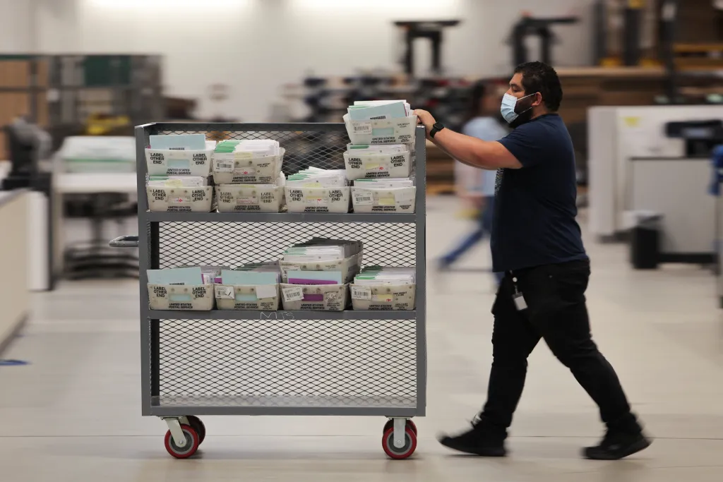 An election worker transports ballots in a cart during the California primary election.