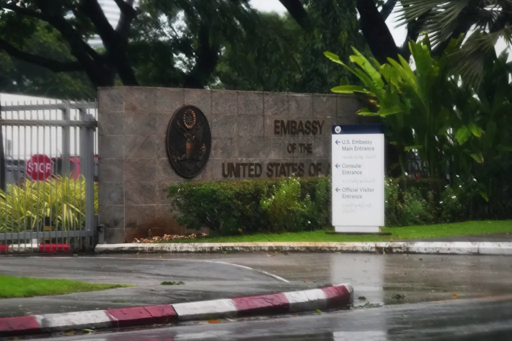Entrance of the U.S. Embassy in Yangon, Myanmar, with a sign detailing directions to various entrances.