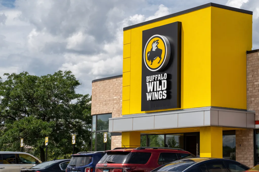 Exterior of a Buffalo Wild Wings restaurant with yellow and brick walls.