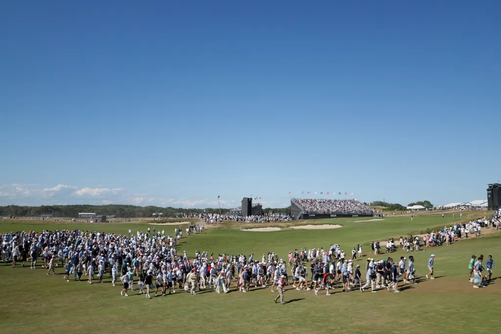 Fans cross the 9th fairway during the final round of the 126th U.S. Open Golf Championship at Shinnecock Hills Golf Club.