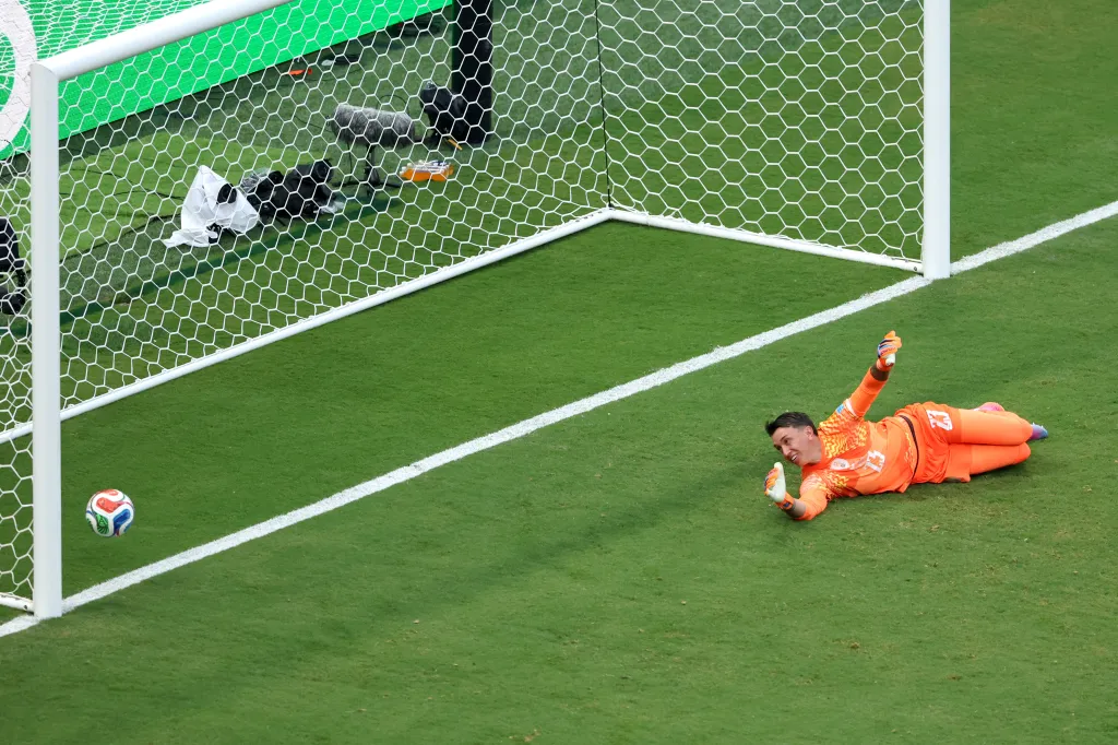 Uruguay's goalkeeper Fernando Muslera lies on the ground after Spain scores a goal in the 2026 FIFA World Cup.