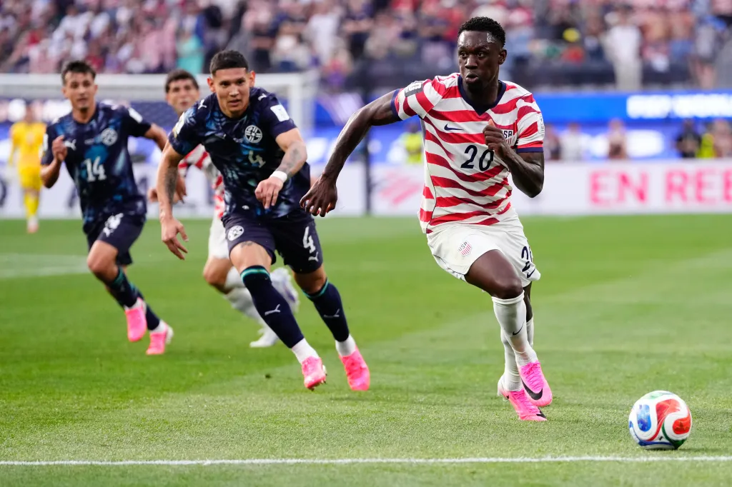 Folarin Balogun of USA runs with the ball during a soccer match against Paraguay.