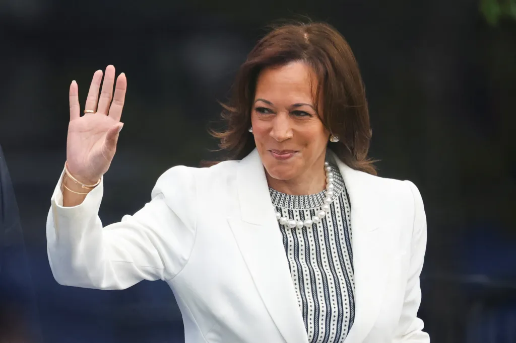 Former U.S. Vice President Kamala Harris waving while attending a dedication ceremony.
